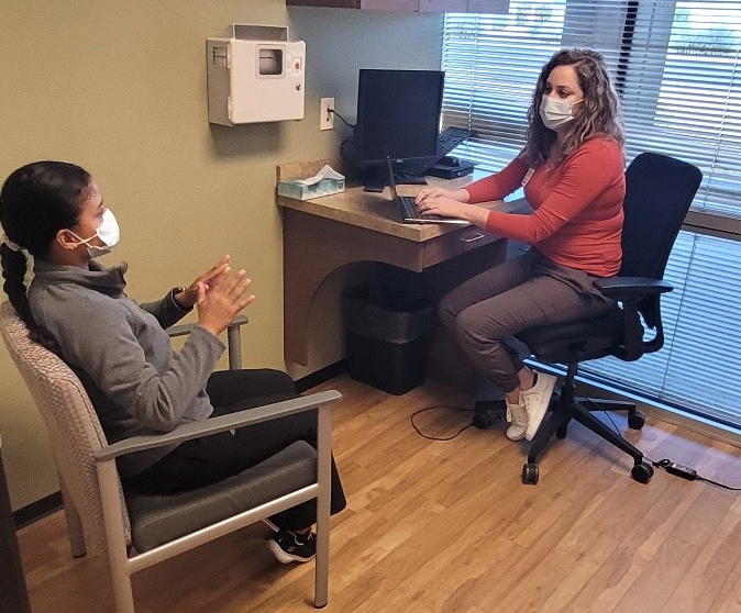 A Behavioral Health Manager in their office speaking with a patient